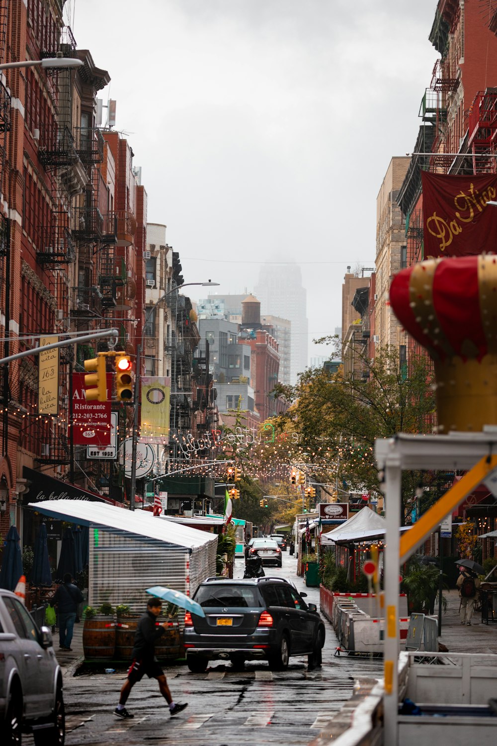 a city street filled with lots of traffic next to tall buildings