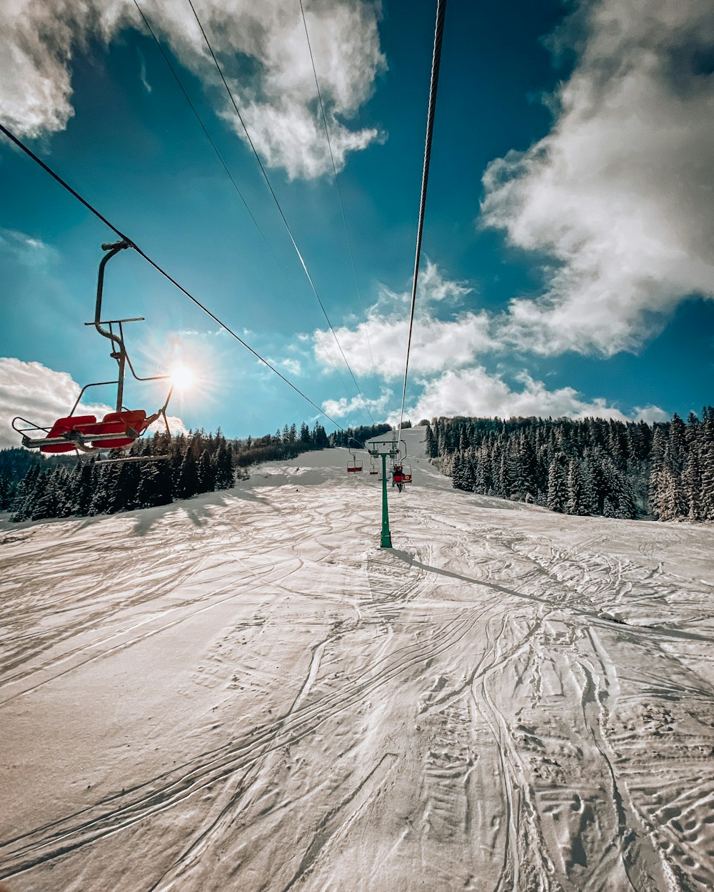 a ski lift going up a snowy hill