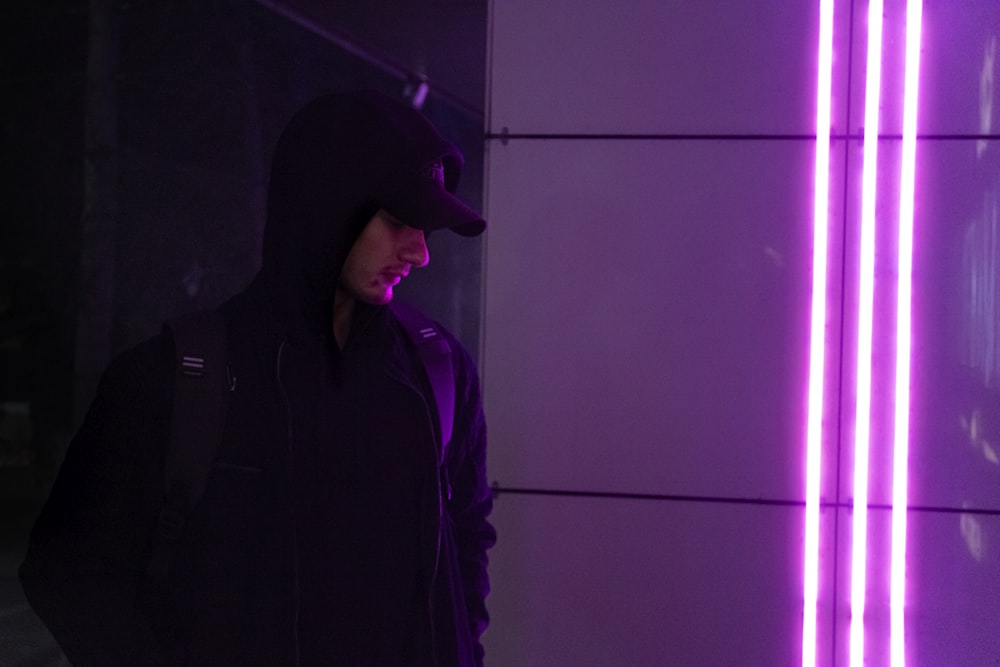 a man standing in front of a purple light