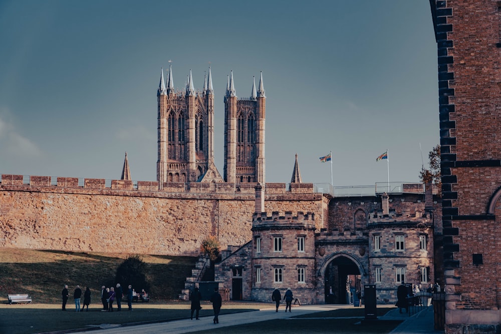 a group of people standing in front of a castle