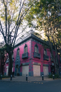 a pink and blue building with lots of windows