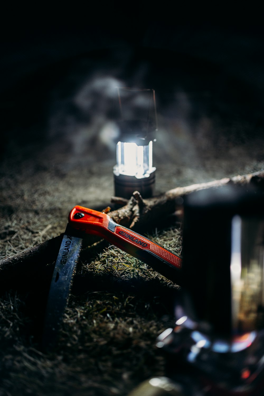 a flashlight and a pair of scissors on the ground