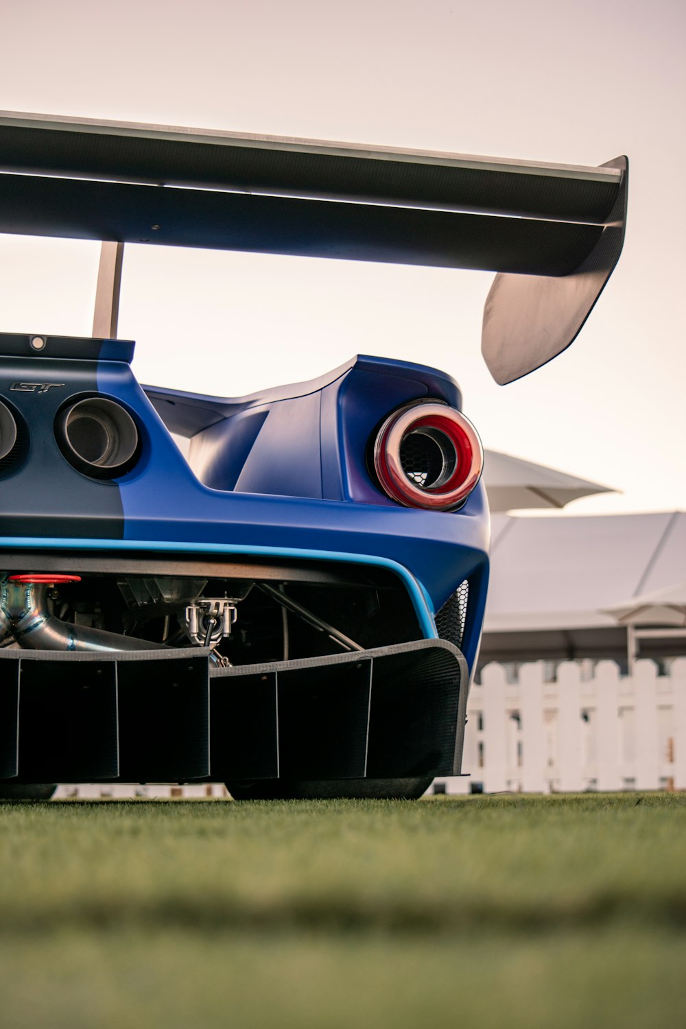 the rear end of a blue sports car