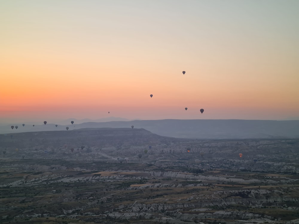 a group of hot air balloons flying in the sky