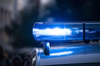 a close up of blue police car with its lights on