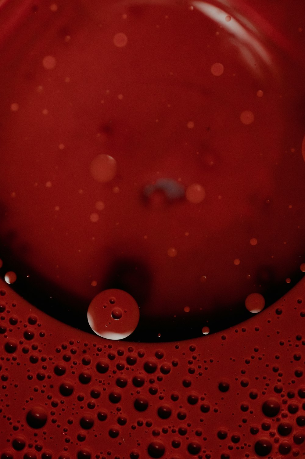 a close up of a red liquid in a bowl