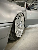 Close-up of a shiny alloy wheel being polished in a modern workshop.