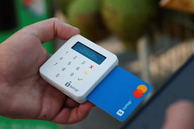 a person holding a credit card and a cell phone