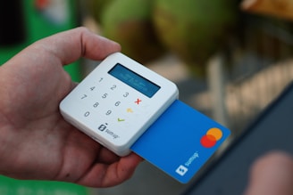 a person holding a credit card and a cell phone