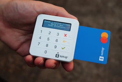 a person holding a credit card and a calculator