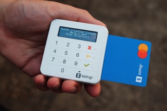 a person holding a credit card and a calculator