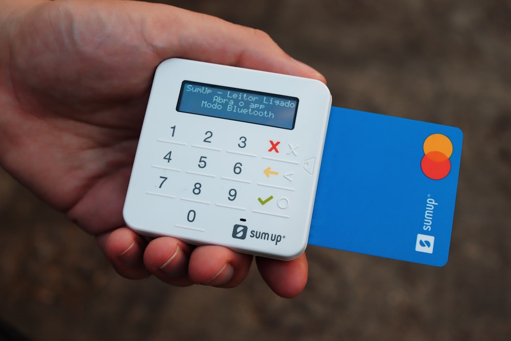 a person holding a credit card and a calculator