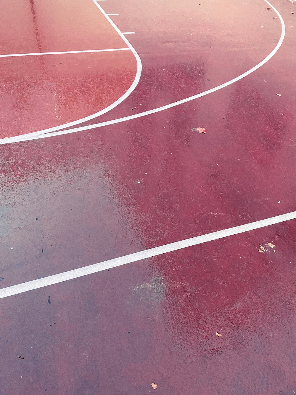a basketball court with a red and white line