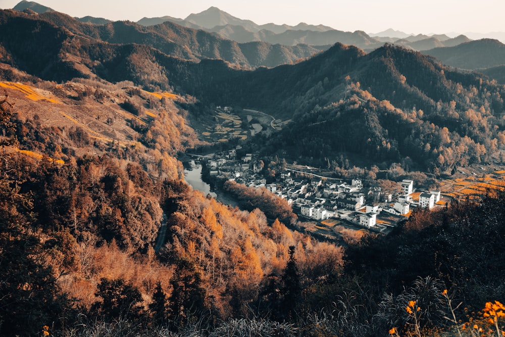 a scenic view of a small town in the mountains