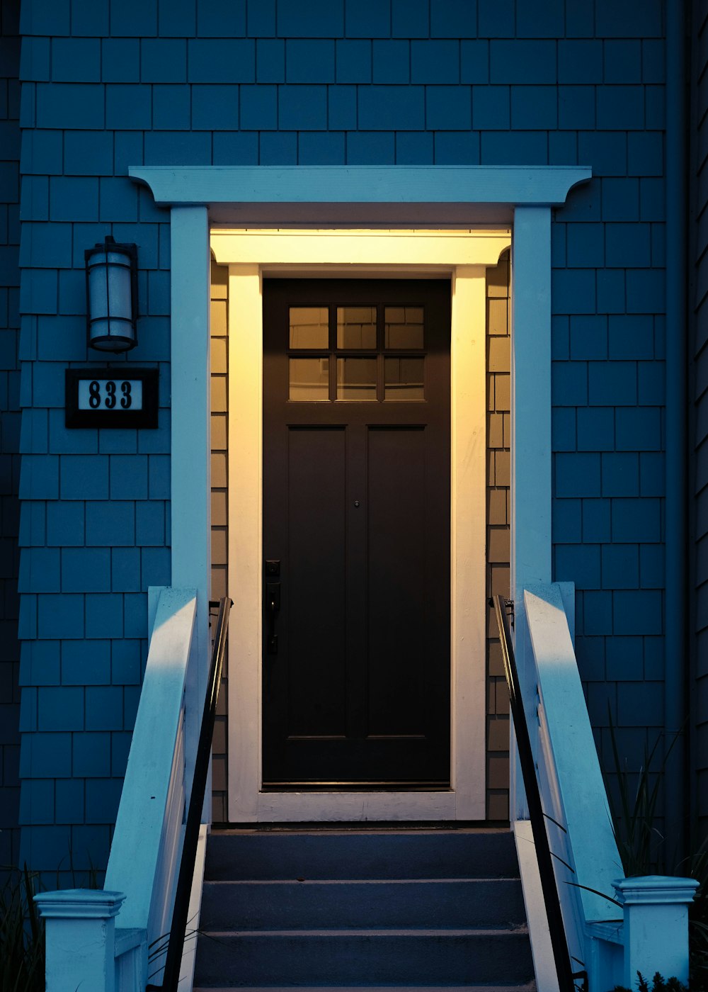 a black door with a light shining on it