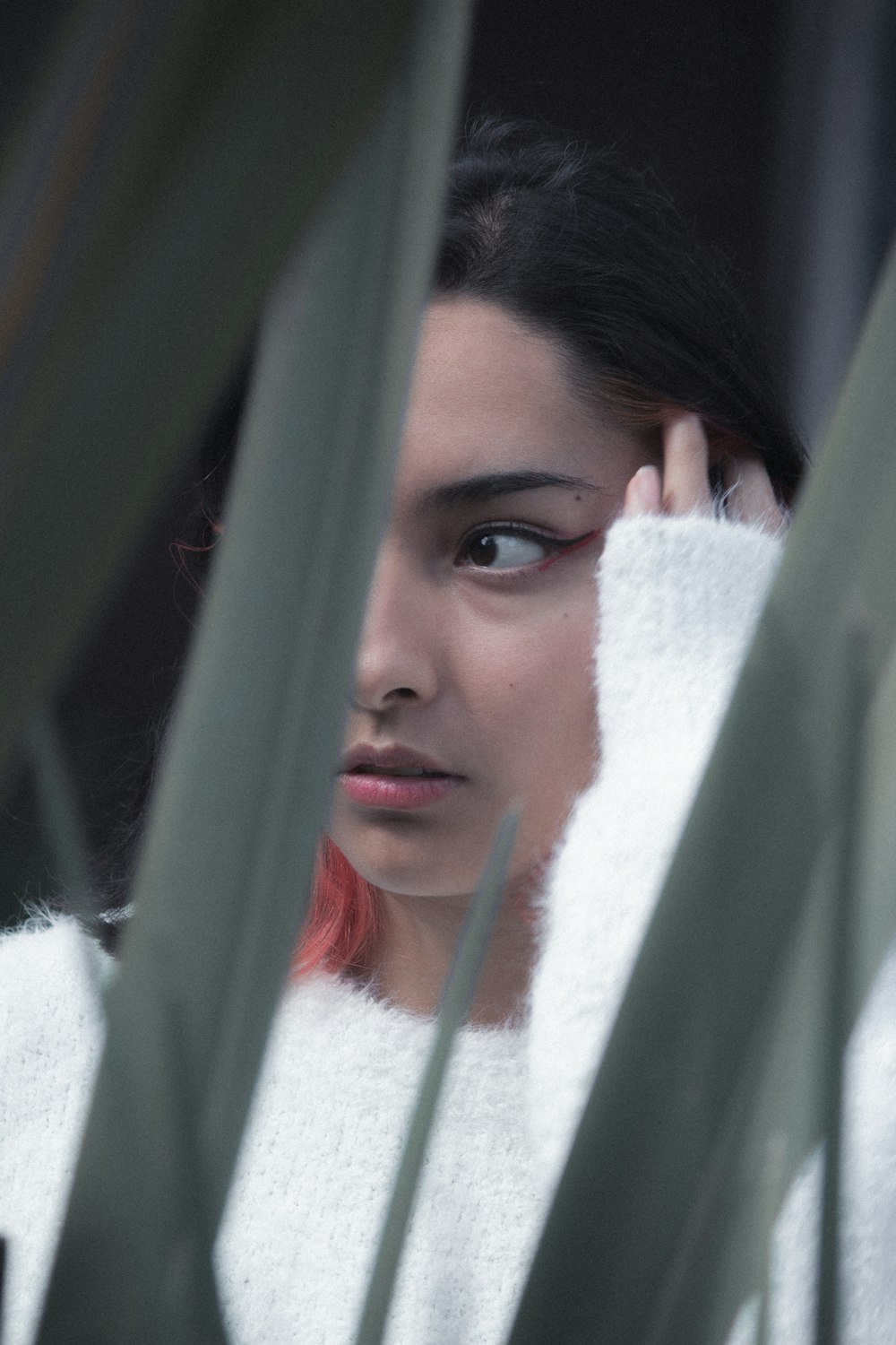 a woman with red hair and a white sweater