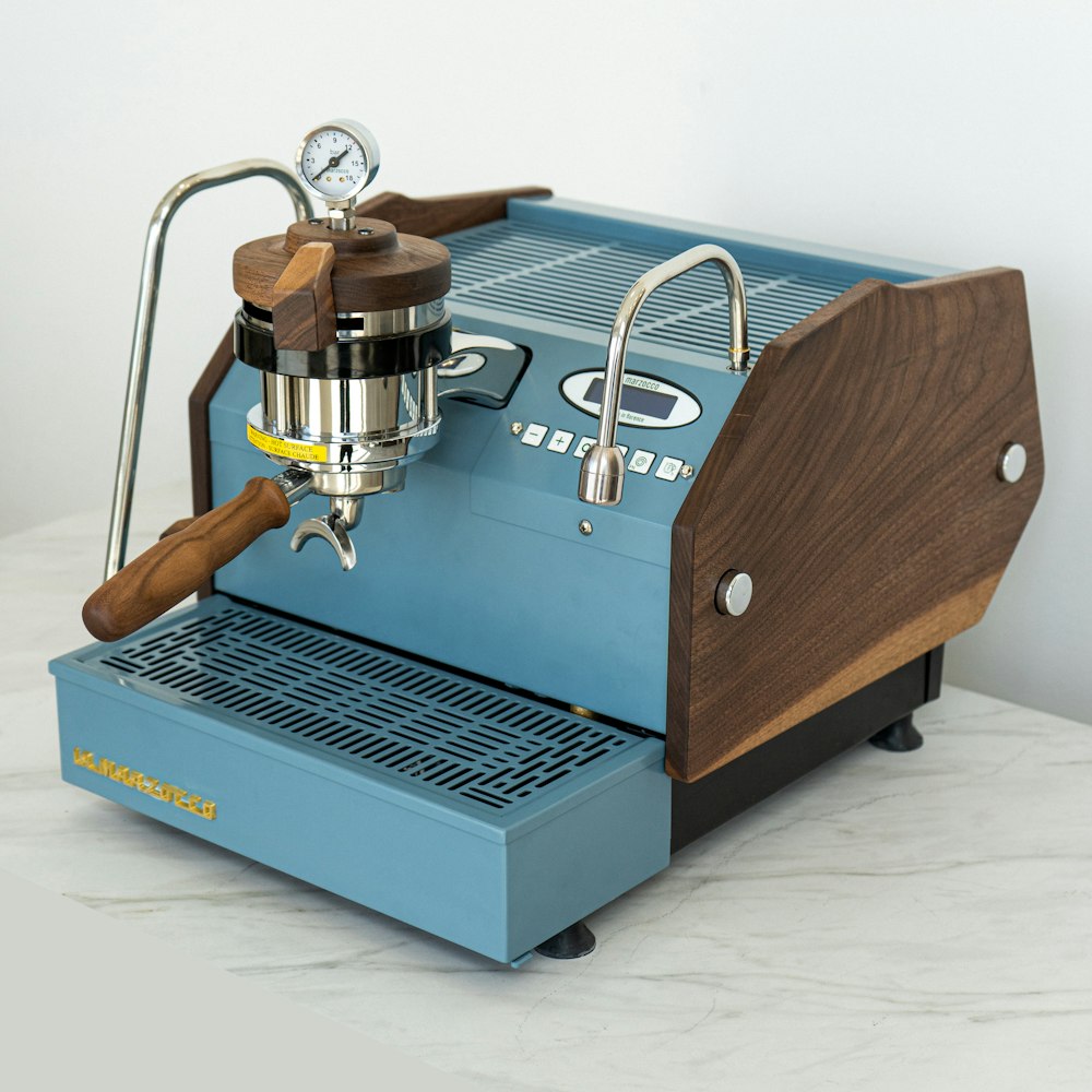 a blue coffee machine sitting on top of a counter