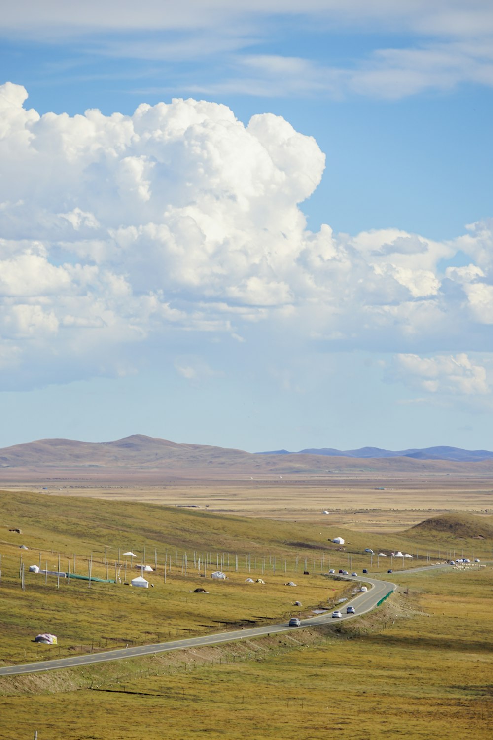 a large open field with a road going through it