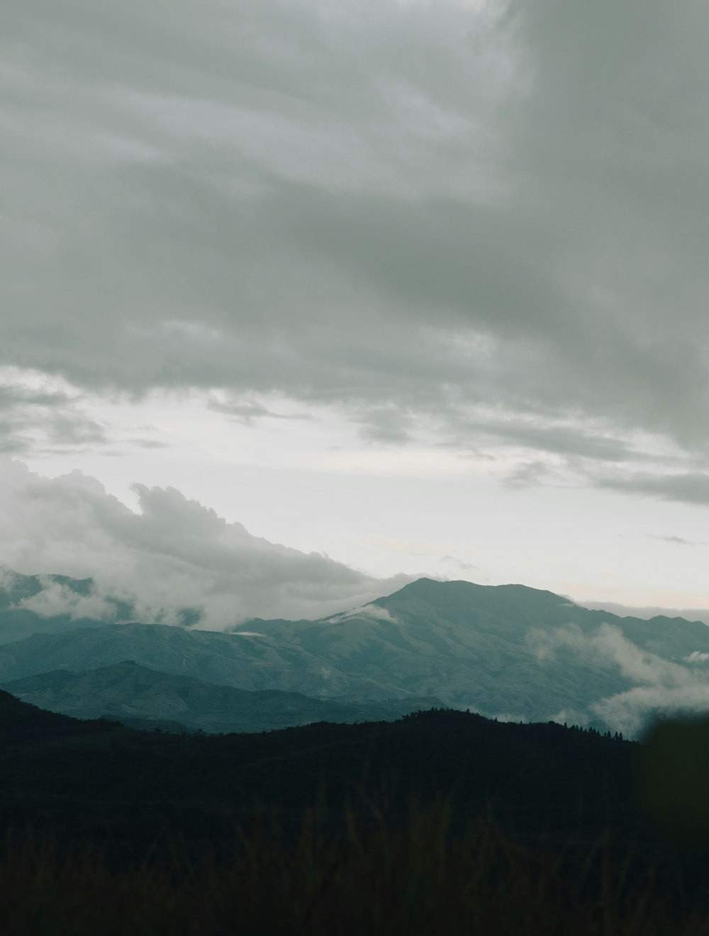 a view of a mountain range with clouds in the sky