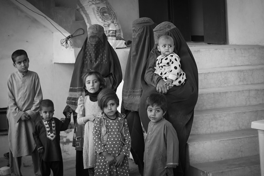 a black and white photo of a group of children