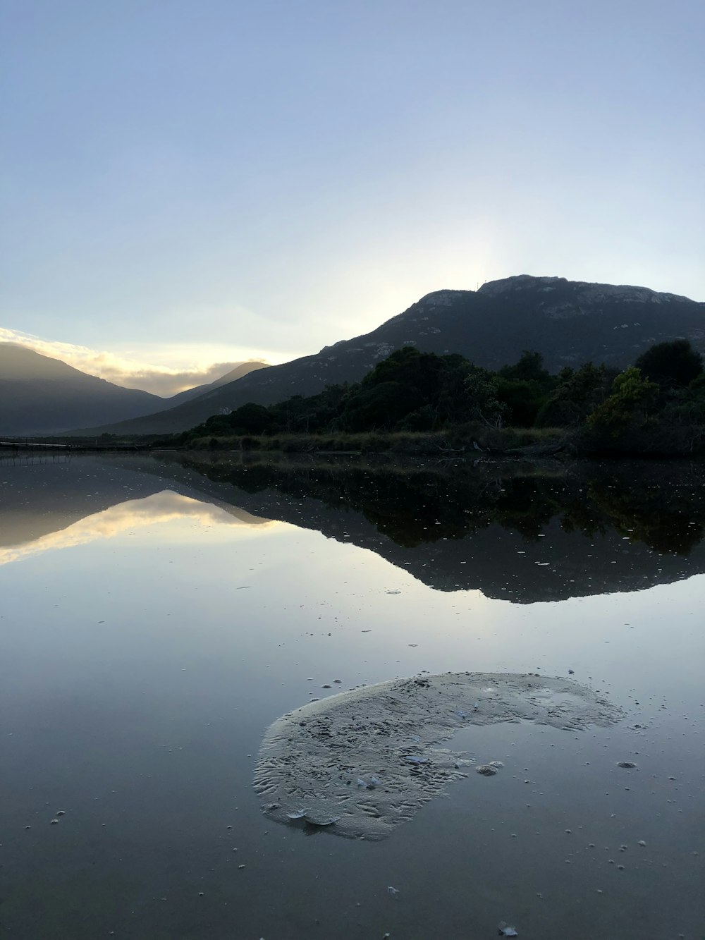 a body of water with a mountain in the background