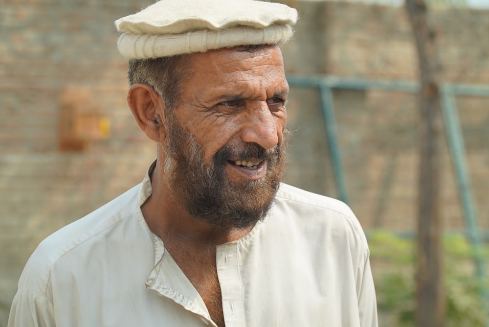 a man with a beard wearing a hat