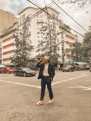 A street colors sneaker stepping confidently on a crosswalk in the heart of downtown.