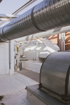 a room with a lot of pipes and a sink