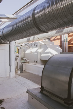 a room with a lot of pipes and a sink