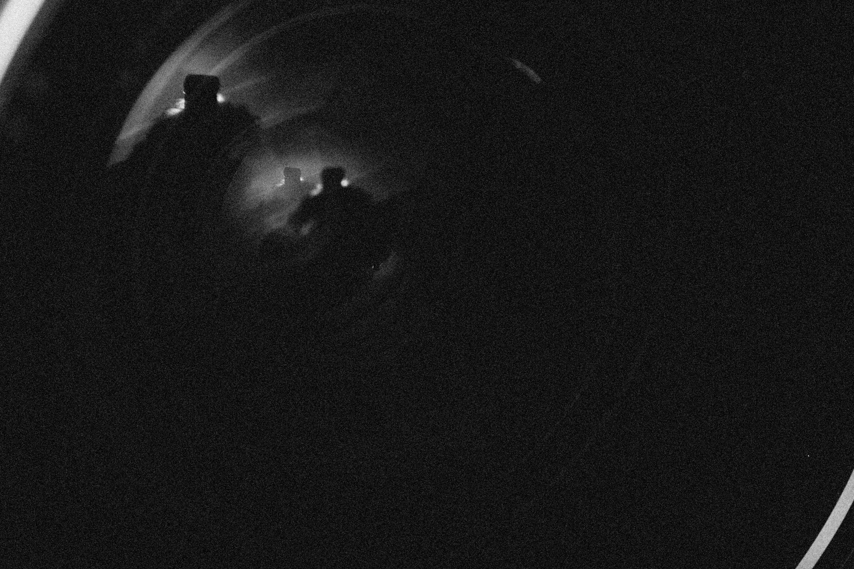 Tense silhouette running through dark tunnel with single light source ahead