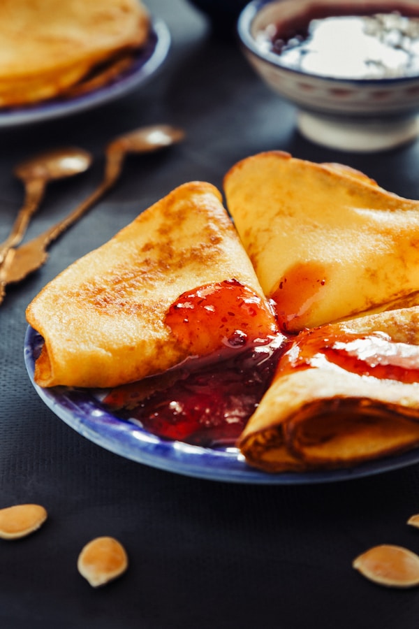 A plate of food with crepes and sauce on it