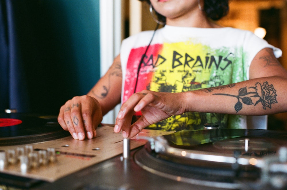 a woman is playing a record on a turntable