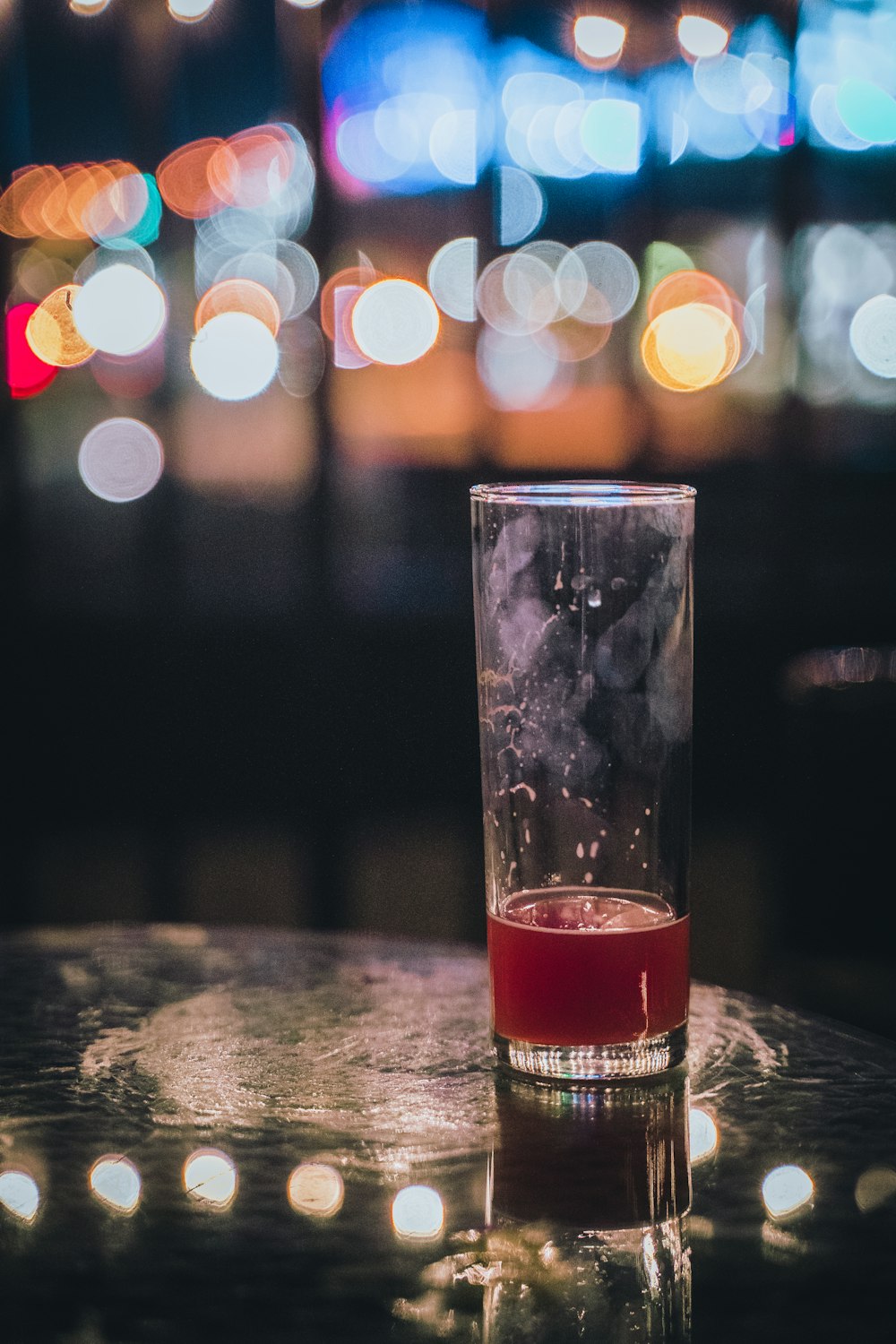 a glass filled with liquid sitting on top of a table