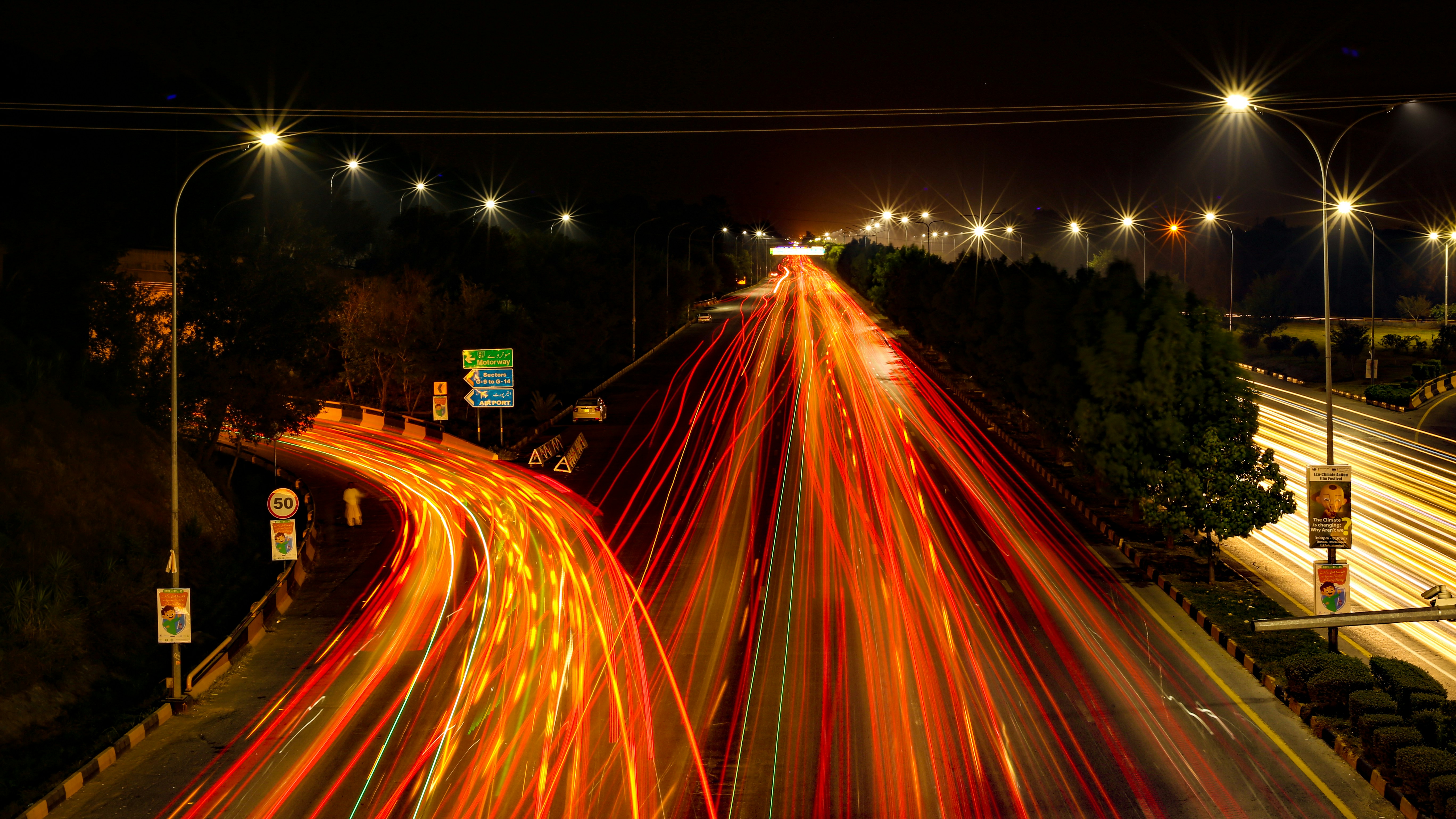 a long exposure photo of a highway at night