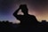 A serene image of a person gazing at the stars in a night sky, symbolizing reflection and guidance.