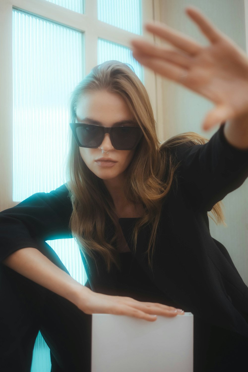 a woman wearing sunglasses sitting in a chair