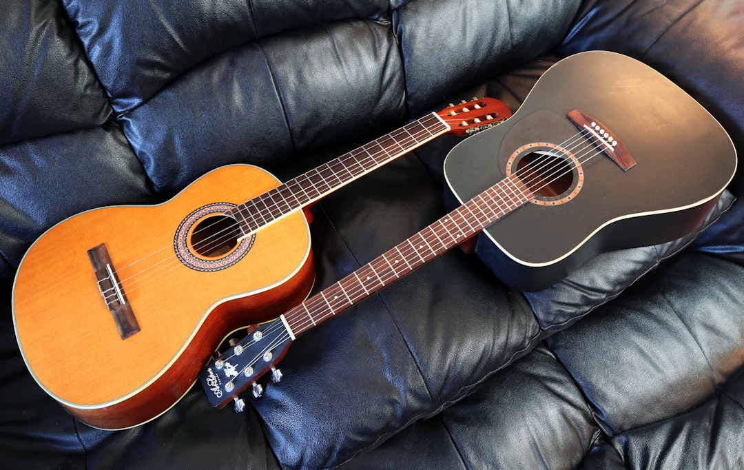 a guitar sitting on top of a blue couch,