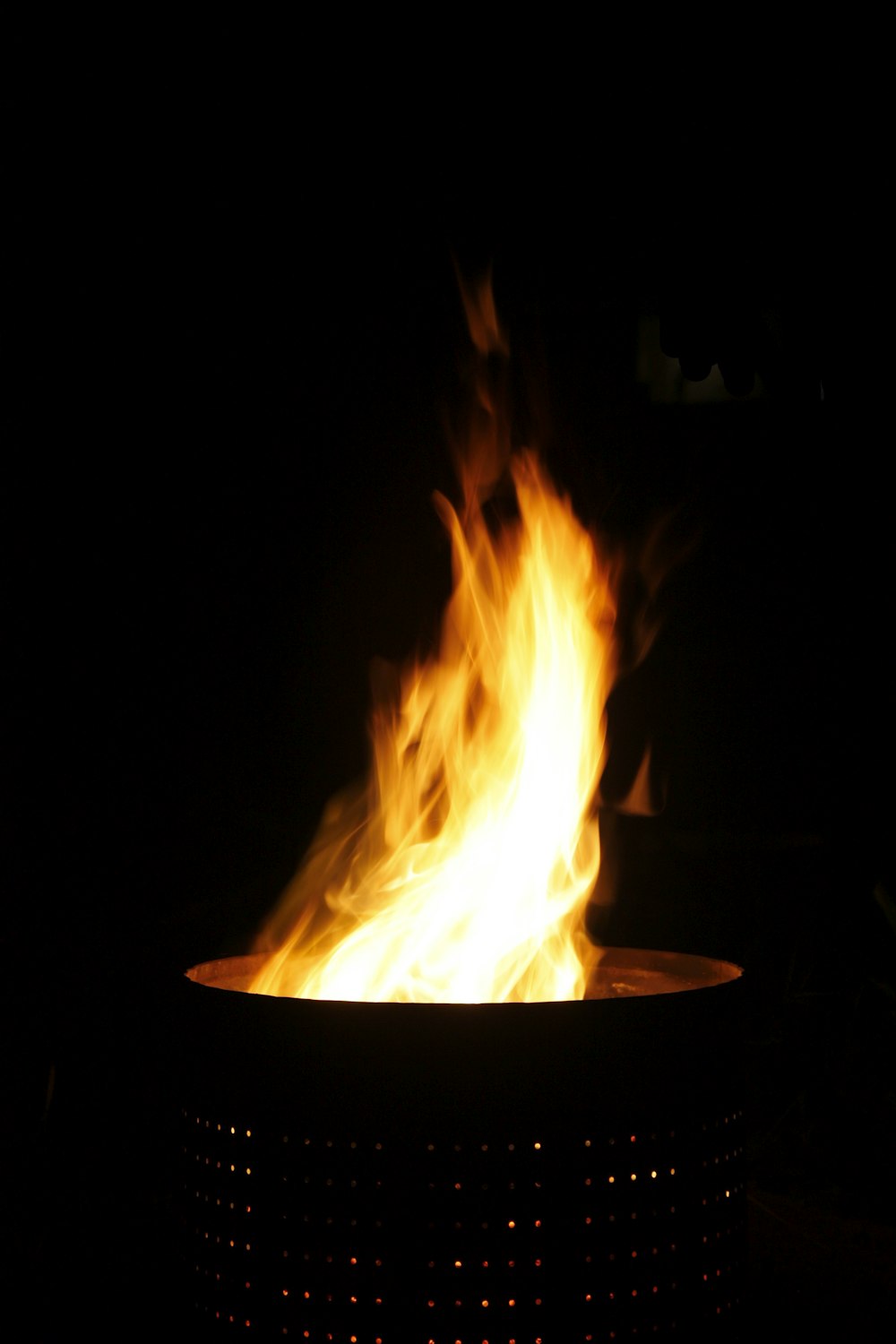 a fire pit is lit in the dark