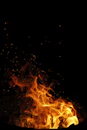 a fire burning in the dark on a black background