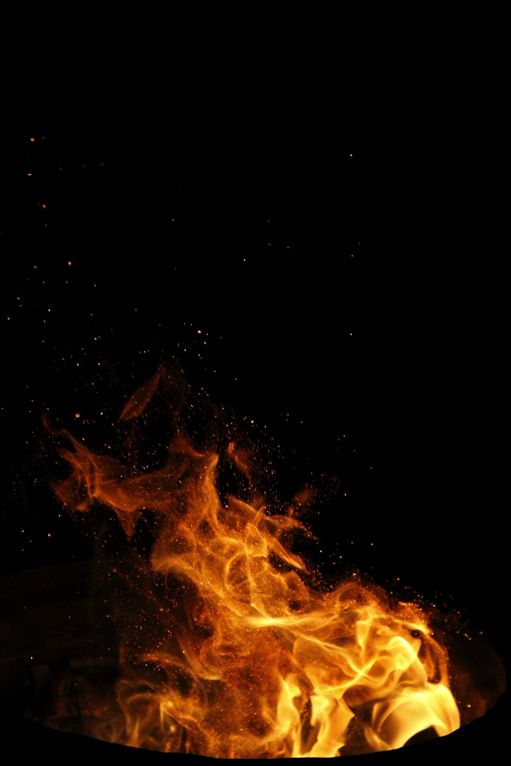 a fire burning in the dark on a black background