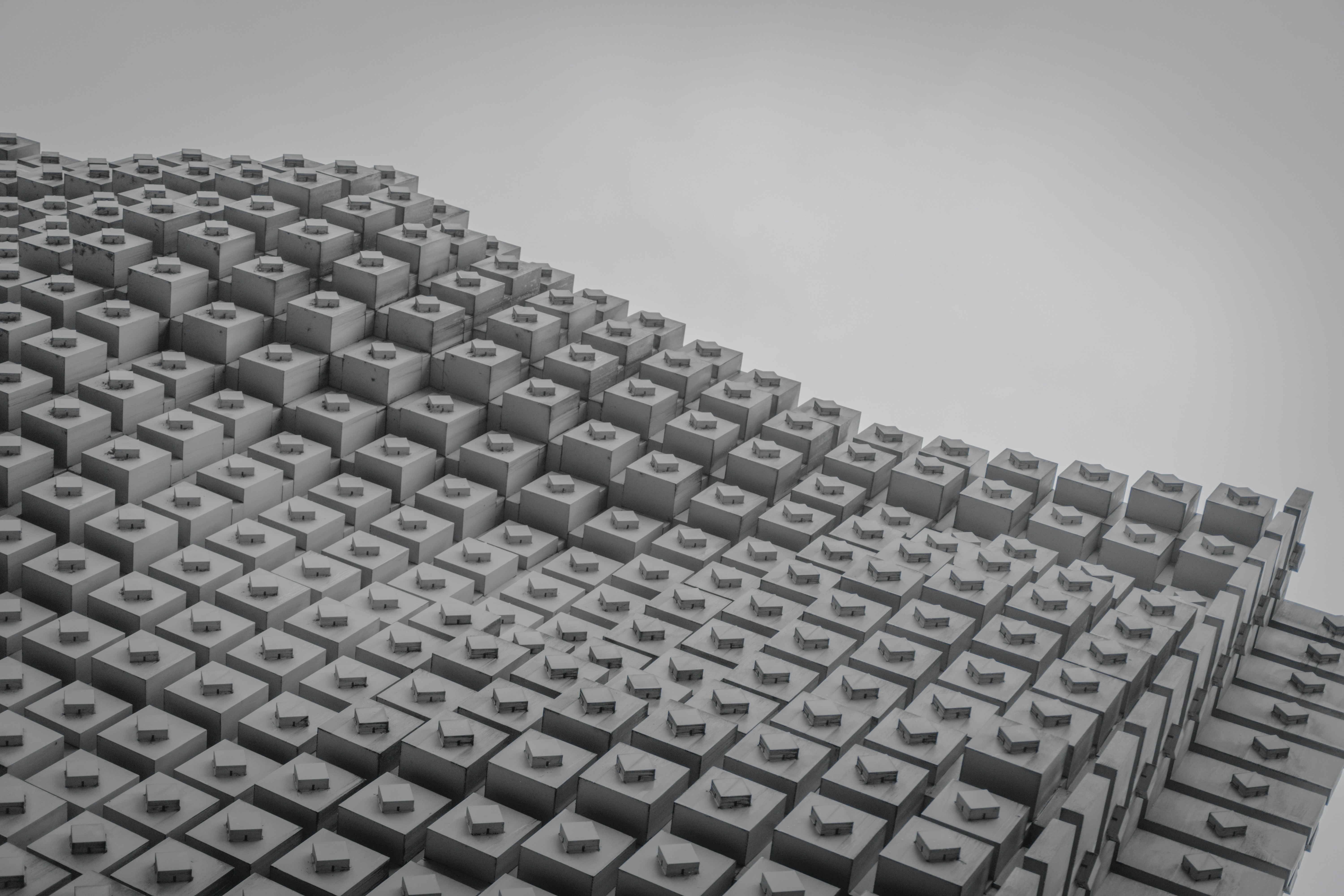 a very large group of cubes with a sky in the background