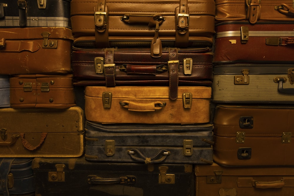 a pile of luggage stacked on top of a suitcase