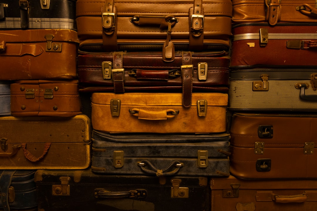 a pile of luggage stacked on top of a suitcase