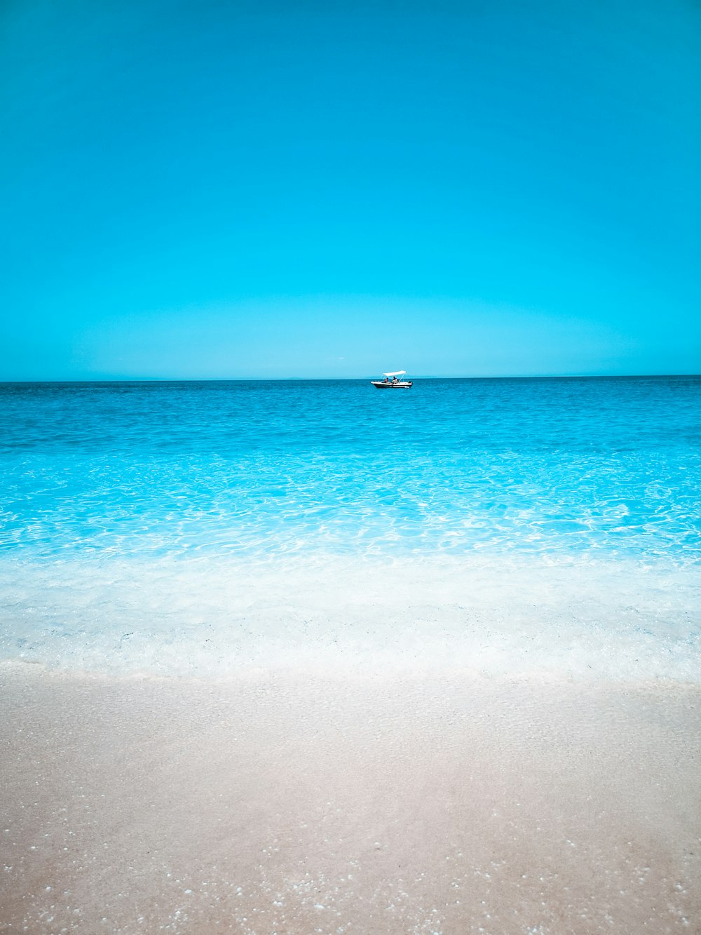 a boat is out in the distance on the ocean