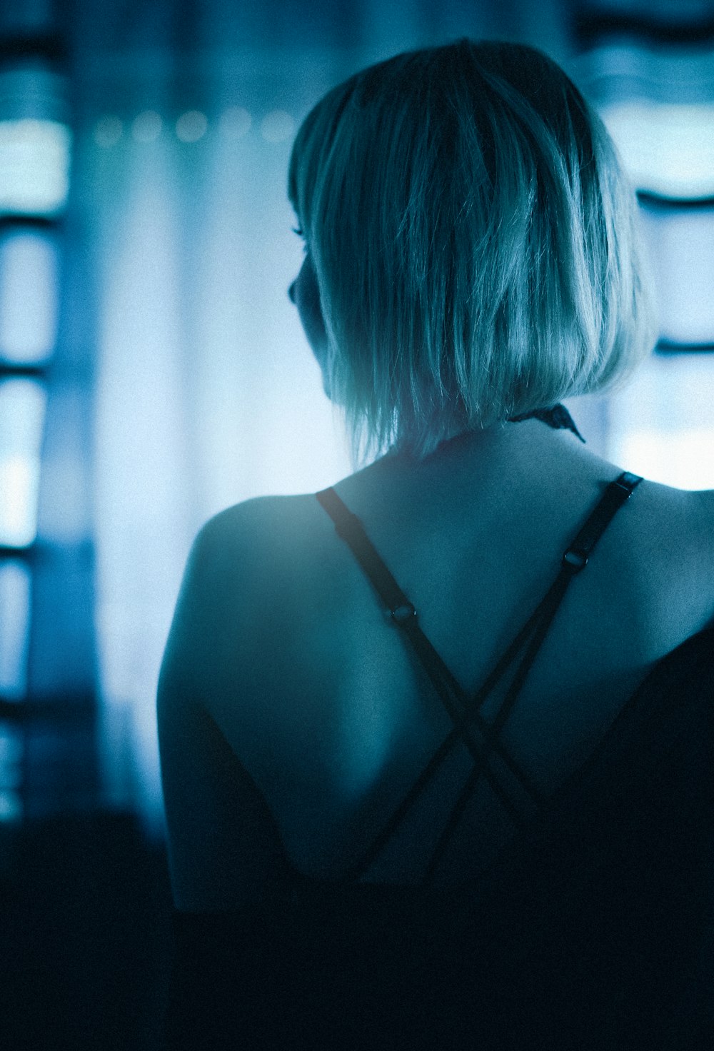 the back of a woman's head in a dark room