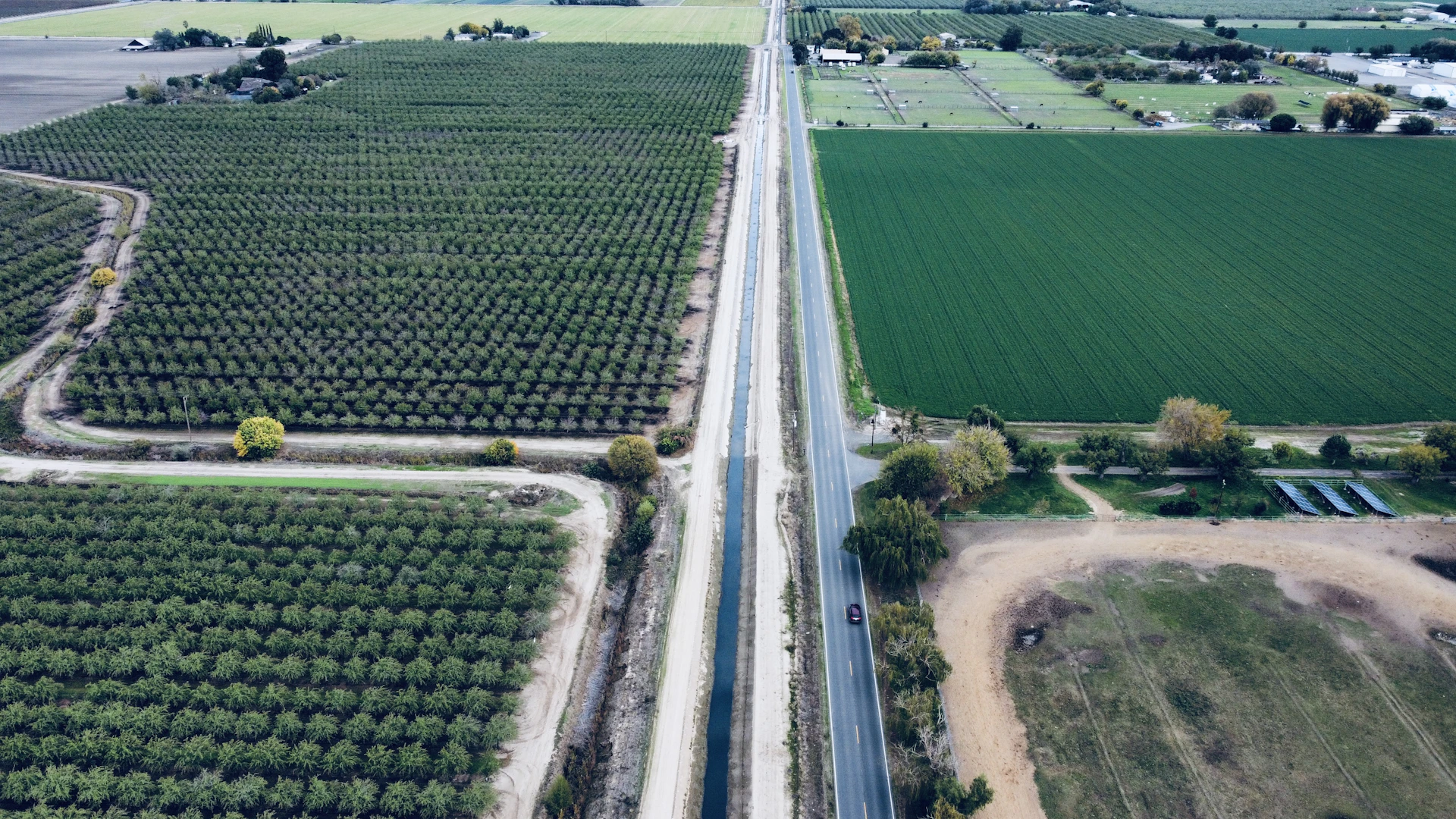 an aerial view of a road running through a field