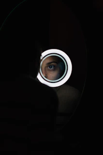 a man looking through a hole in the wall
