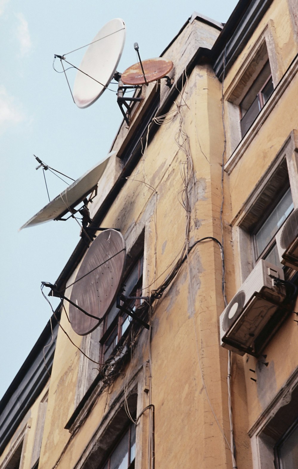 a satellite dish mounted to the side of a building
