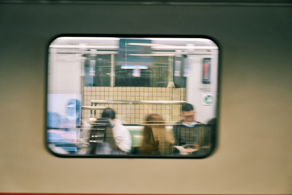 a group of people sitting next to each other on a train