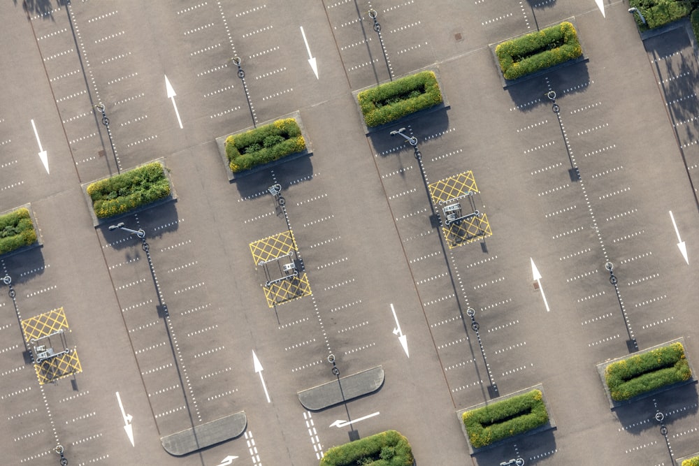 an aerial view of a parking lot with trees